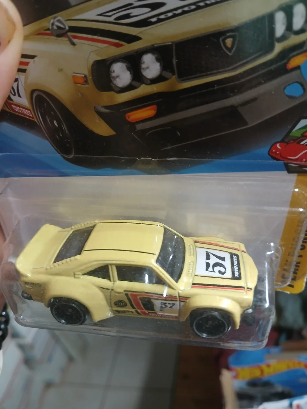 1:64 scale die-cast yellow Mazda RX-3 from the Hot Wheels Peak Pursuit series (n